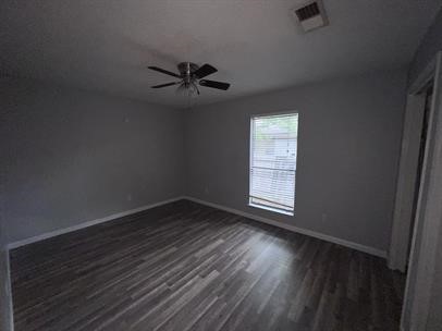 5011 Copperbend Boulevard, Unit B Austin, TX 78744 - Photo 8 of 10 a view of empty room with wooden floor and fan