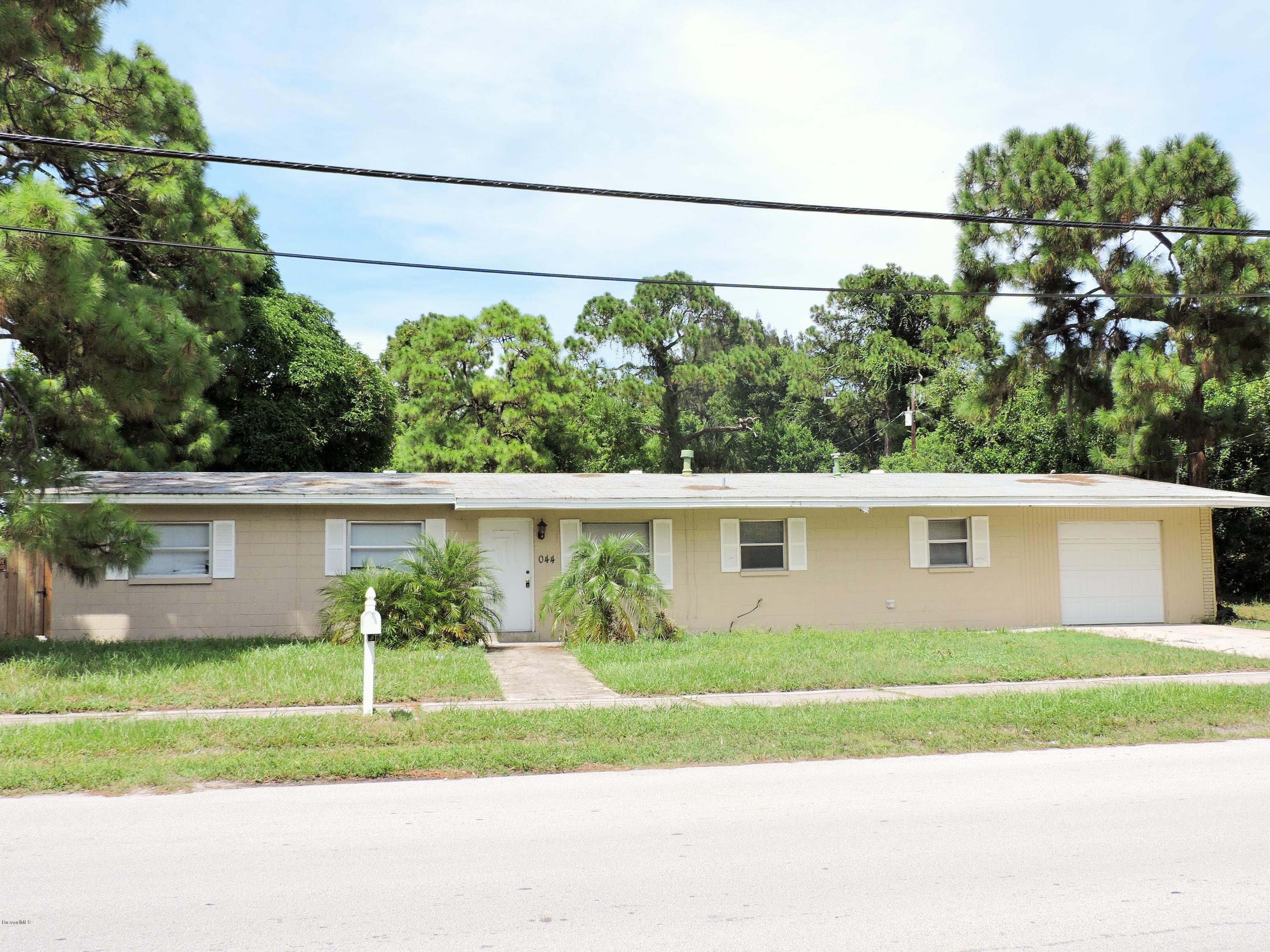 1044 Holmes Street Cocoa, FL 32922 - Photo 1 of 5 a view of a house with a yard