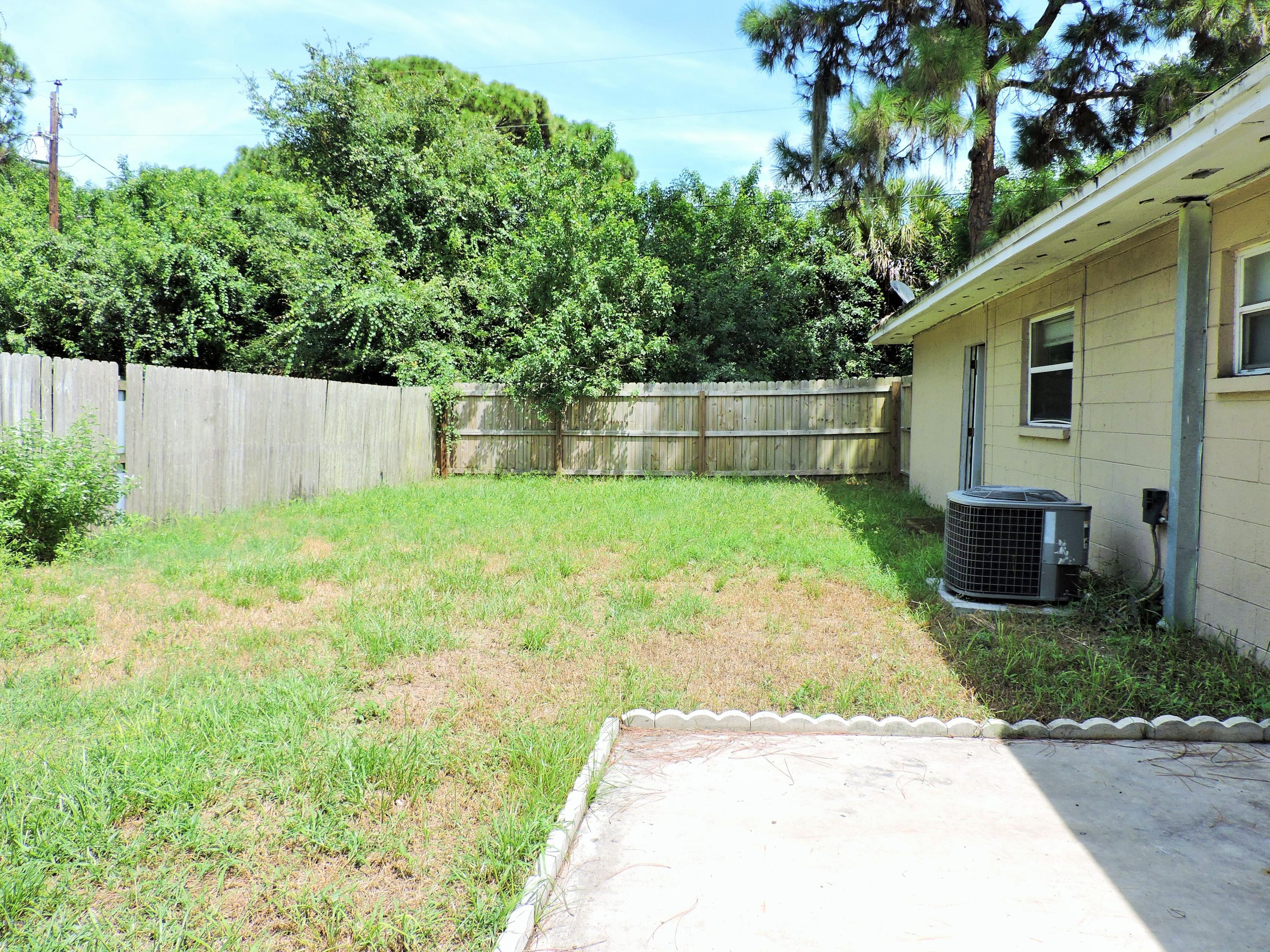 1044 Holmes Street Cocoa, FL 32922 - Photo 5 of 5 a backyard of a house with seating space