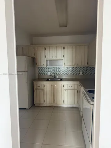 a kitchen with granite countertop a cabinets and steel stainless steel appliances