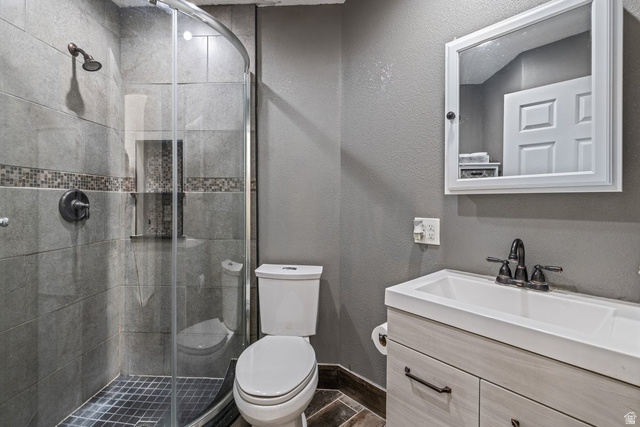 19 South 820 East Tooele, UT 84074 - Photo 22 of 46 Bathroom with a textured wall, vanity, and a shower stall