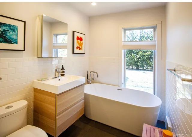 a bathroom with a sink a mirror and a window