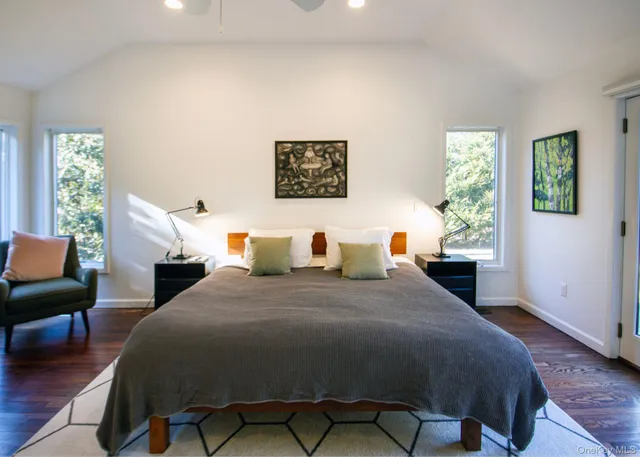 a bed room with a bed and a chair