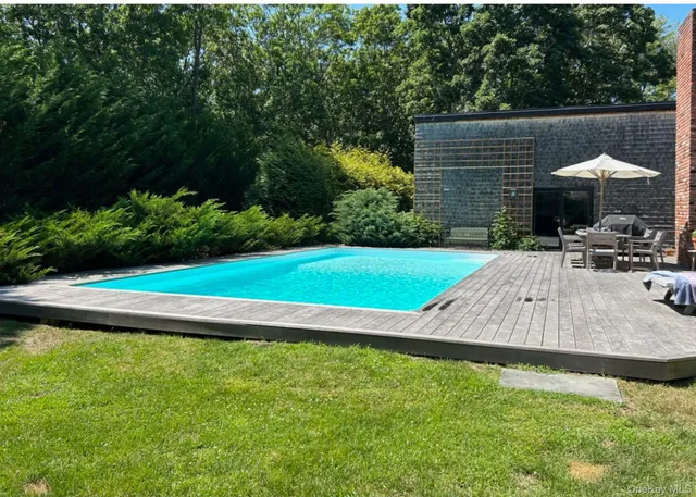 a view of a backyard with swimming pool