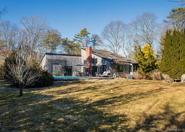 a view of a house with a yard covered with snow in the background
