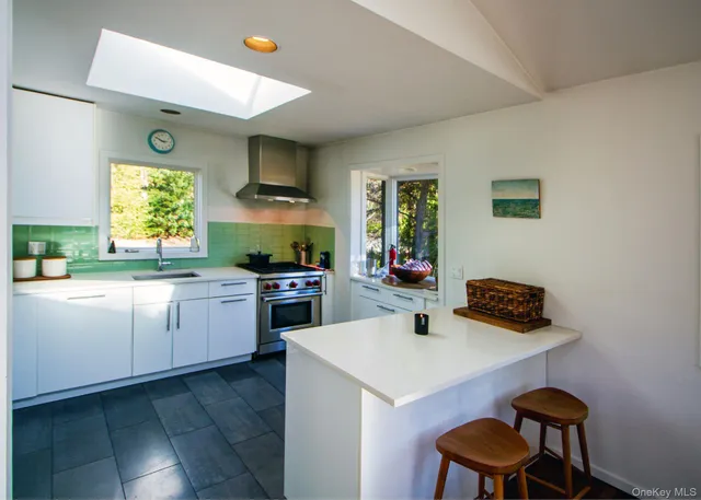 a kitchen with a sink cabinets and window