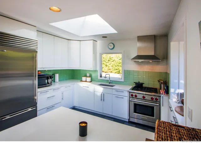 a kitchen with a sink appliances and cabinets