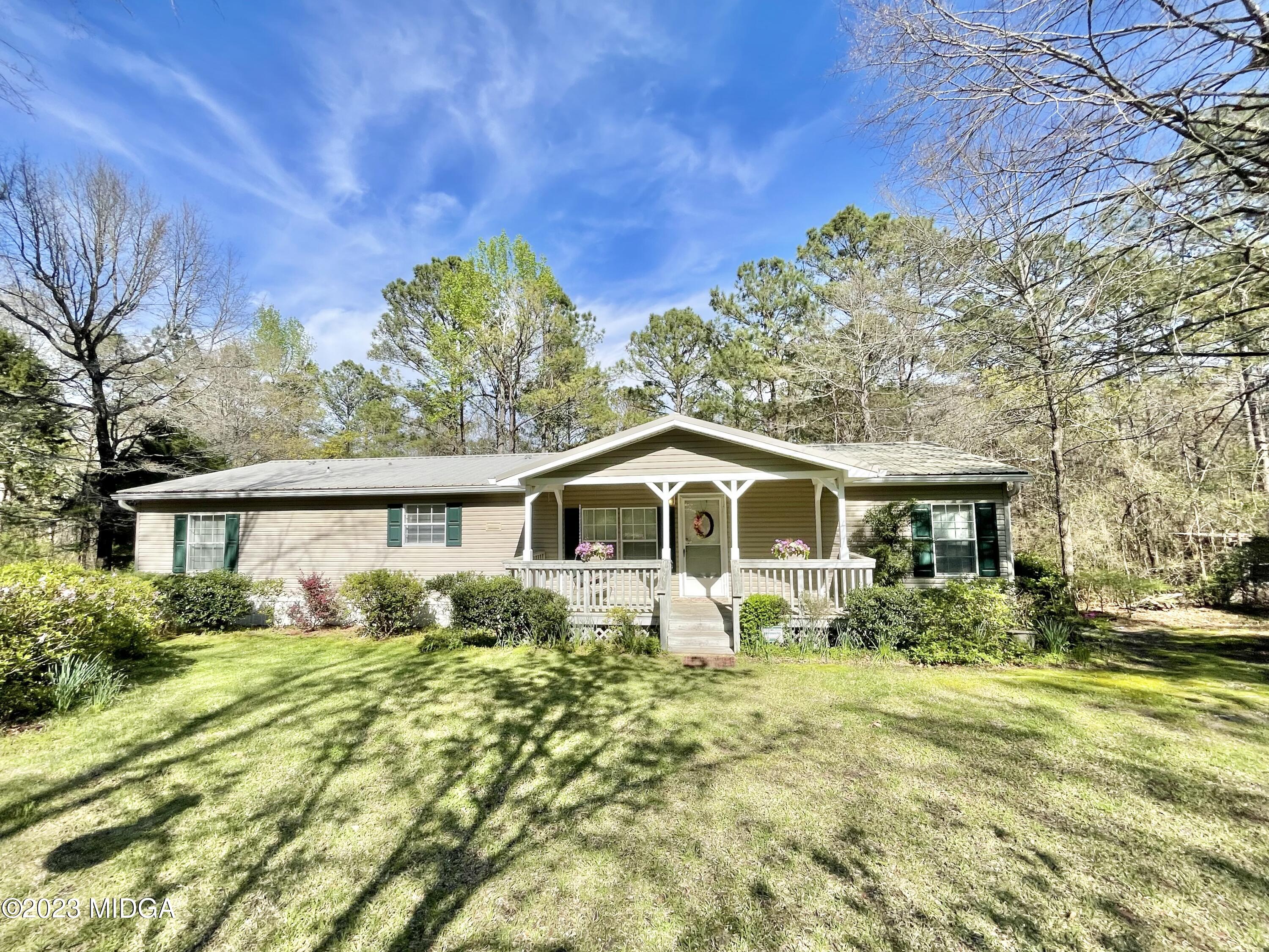 5933 Moseley Dixon Road Macon, GA 31220 - Photo 1 of 38 a front view of house with yard and trees around