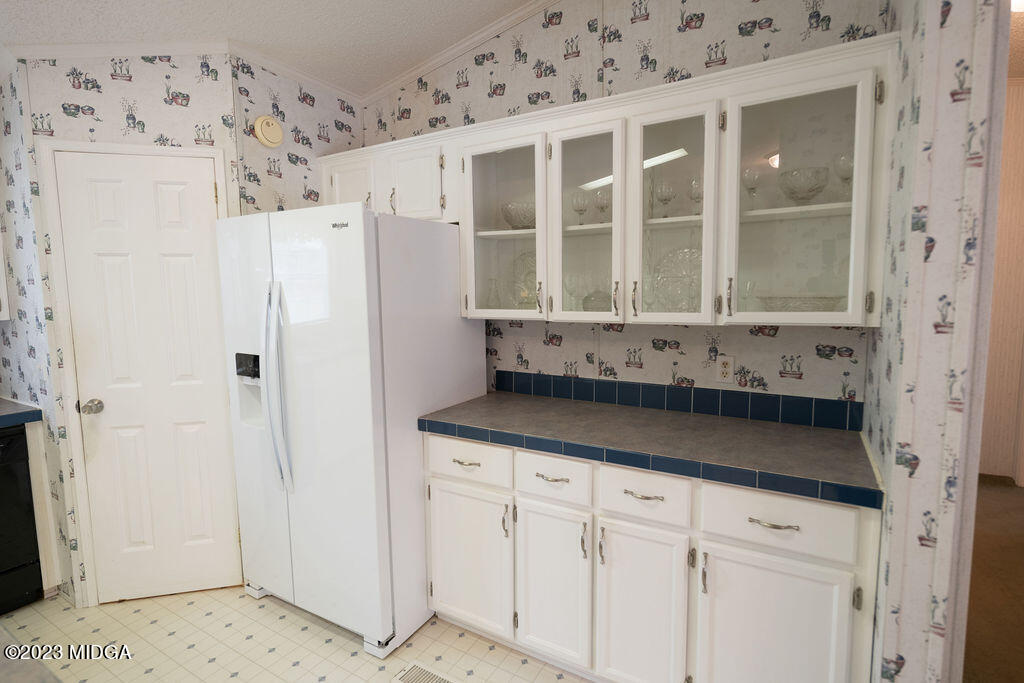 5933 Moseley Dixon Road Macon, GA 31220 - Photo 11 of 38 a bathroom with a granite countertop sink and washing machine