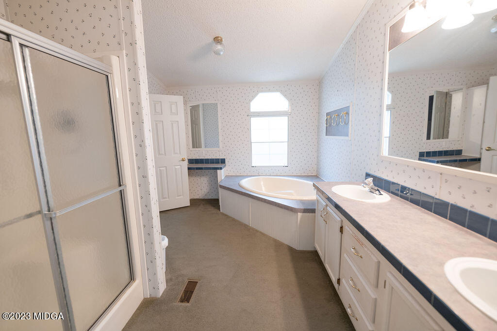 5933 Moseley Dixon Road Macon, GA 31220 - Photo 14 of 38 a bathroom with a granite countertop sink toilet and shower