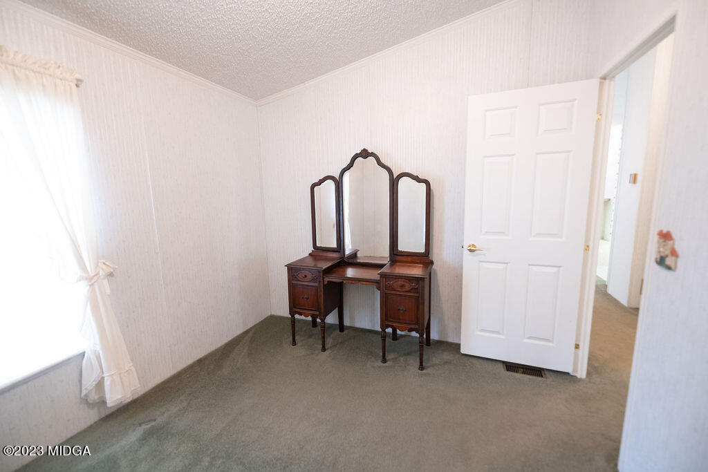 5933 Moseley Dixon Road Macon, GA 31220 - Photo 21 of 38 a room with a table and a chair