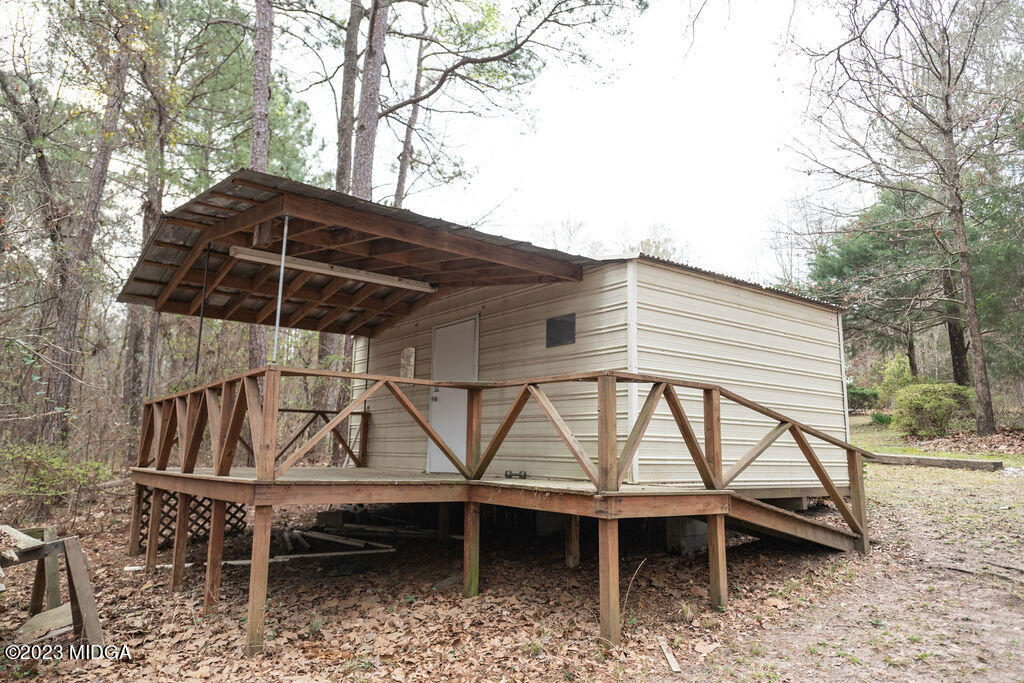 5933 Moseley Dixon Road Macon, GA 31220 - Photo 30 of 38 a roof deck with table and chairs under an umbrella