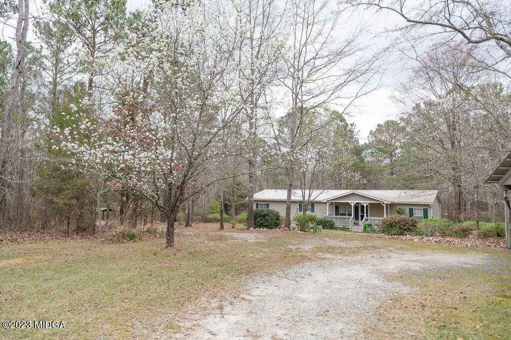 5933 Moseley Dixon Road Macon, GA 31220 - Photo 38 of 38 a front view of a house with a yard and trees