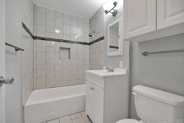 a bathroom with a sink a toilet and bathtub