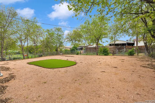 a view of a backyard with large trees
