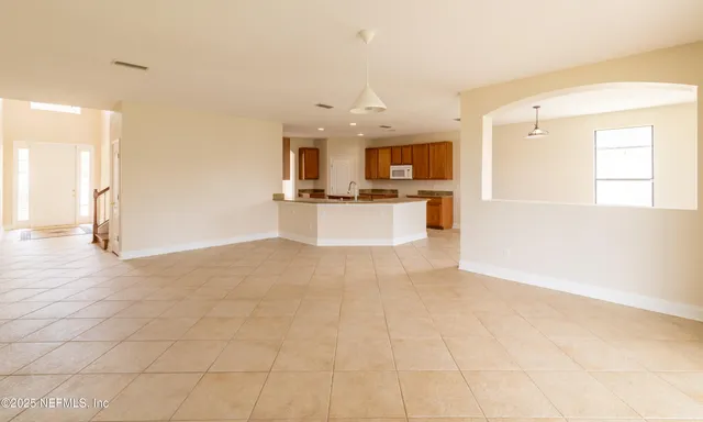a kitchen with stainless steel appliances a refrigerator and a stove top oven