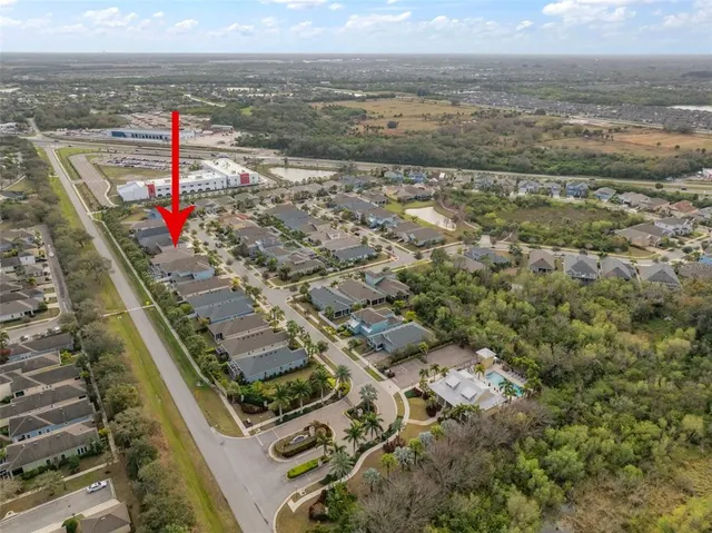 an aerial view of a house with a yard