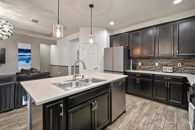 a view of a refrigerator in kitchen and wooden floor