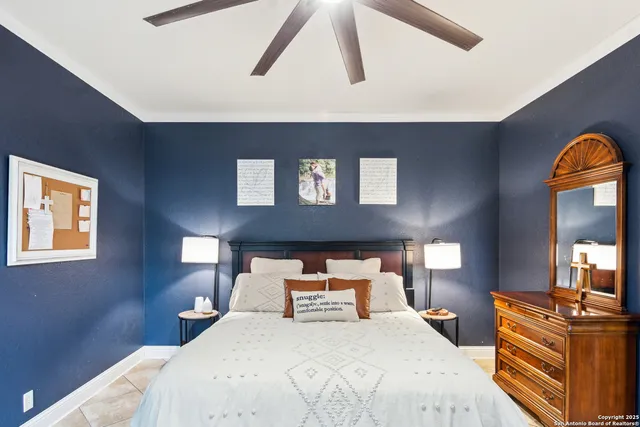 a bedroom with a bed and lamp on dresser