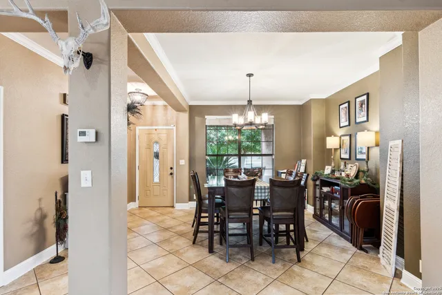 a view of a dining room with furniture and chandelier
