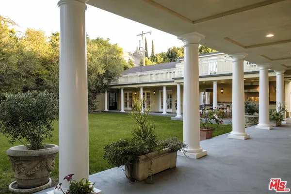 an aerial view of a house with a garden and pool