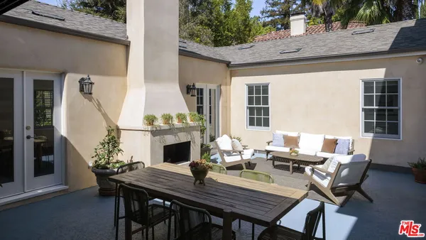 a view of a dining table and chairs in the patio