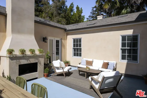 a balcony with furniture and a fireplace