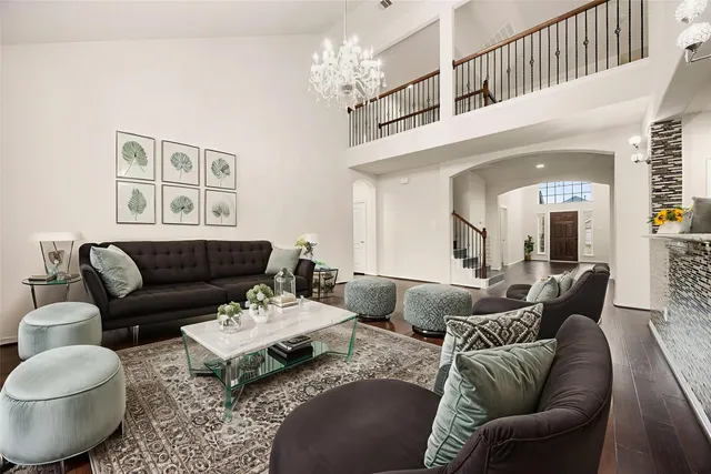 a living room with furniture and a chandelier