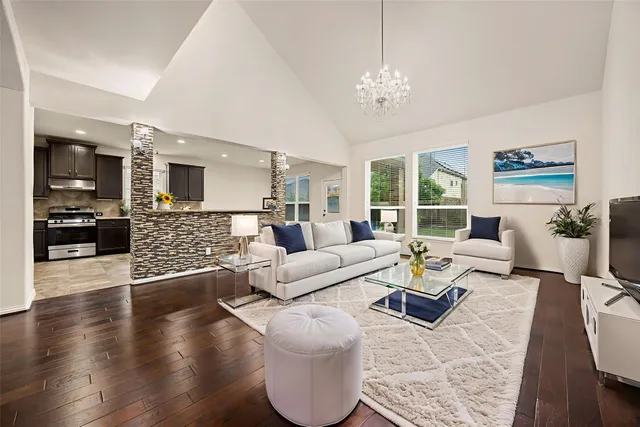 a living room with furniture and a chandelier