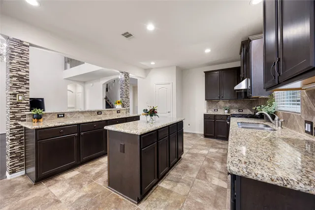 a large kitchen with granite countertop lots of counter top space