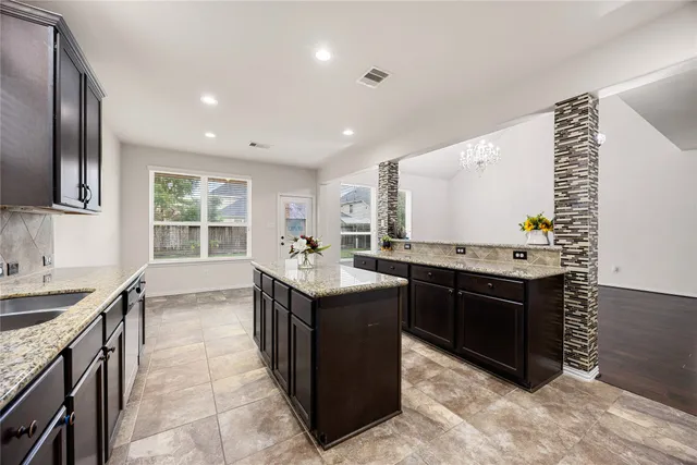 a kitchen with a stove sink and cabinets