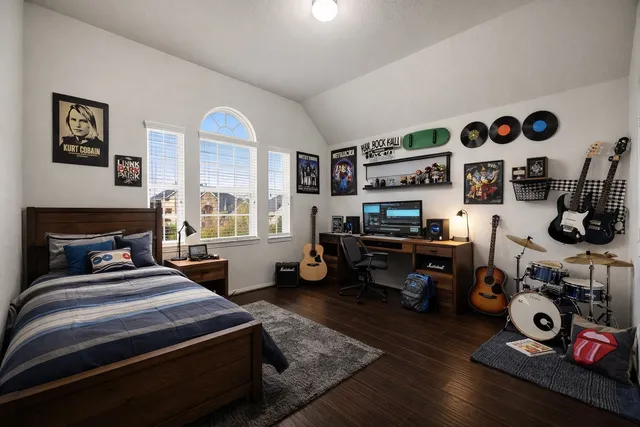 a bedroom with bed and a desk