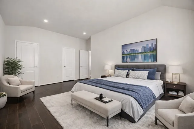 a spacious bedroom with a bed and a couch