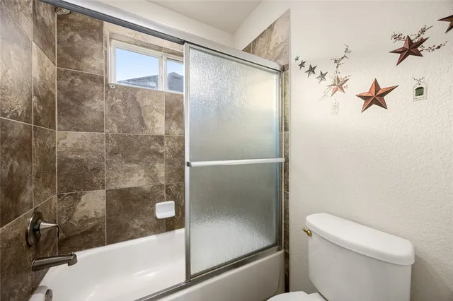a bathroom with a shower and toilet