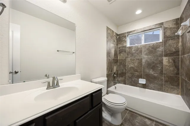 a bathroom with a sink a toilet and bathtub