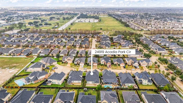 an aerial view of residential houses with outdoor space and swimming pool
