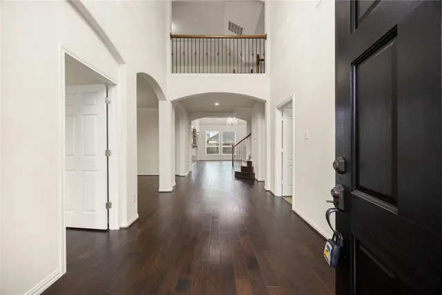 wooden floor in an empty room with a gallery