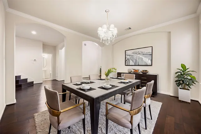 a view of a dining room with furniture wooden floor and chandelier