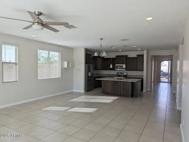 a large kitchen with cabinets and stainless steel appliances