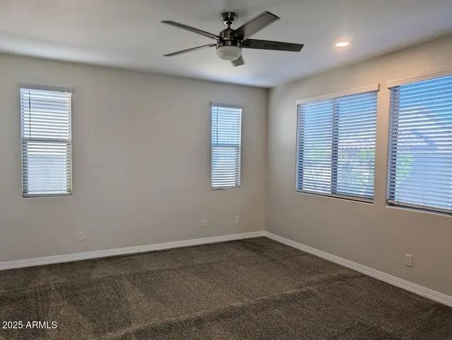a view of a livingroom with a ceiling fan and window