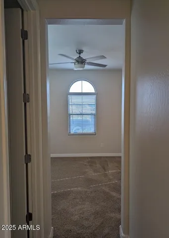 a bathroom with a window and a glass door shower
