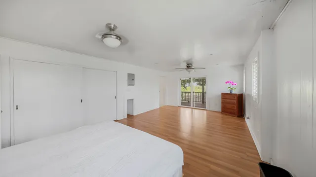 a view of a livingroom with wooden floor and entryway