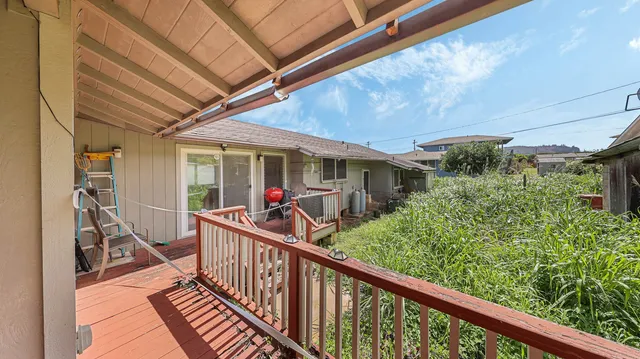 a view of a house with backyard and deck