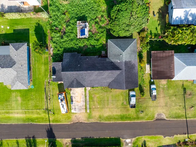 an aerial view of a house with a yard