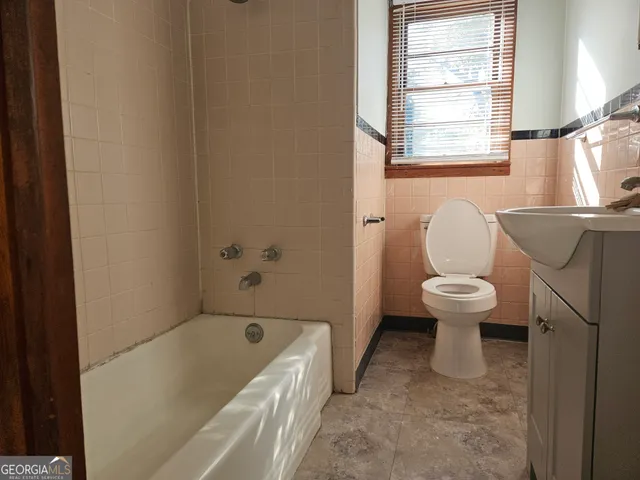 a bathroom with a toilet and a bathtub
