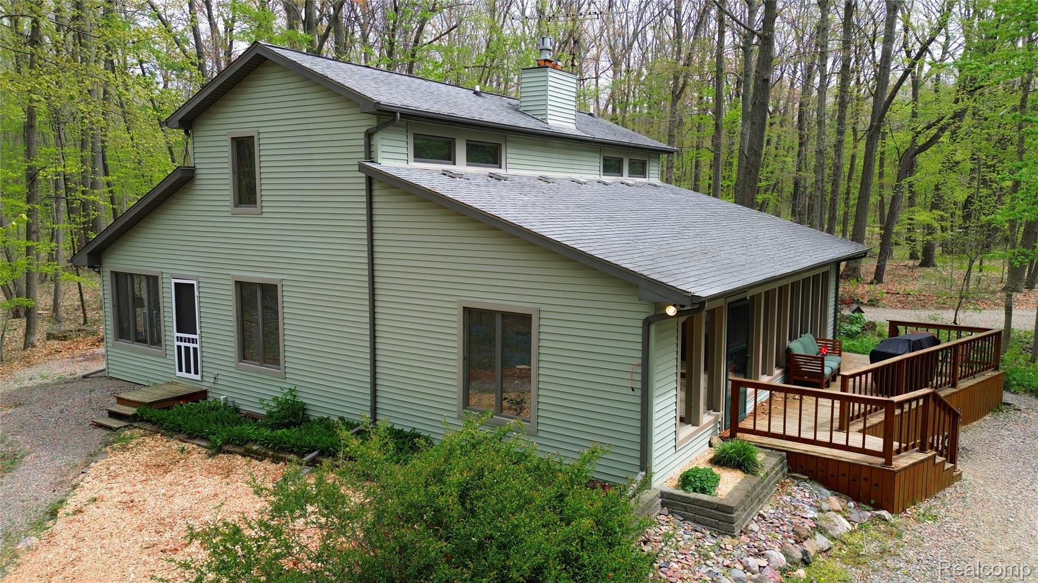 3910 Joy Road Metamora, MI 48455 - Photo 26 of 26 View of side of home featuring roof with shingles, a chimney, and a deck