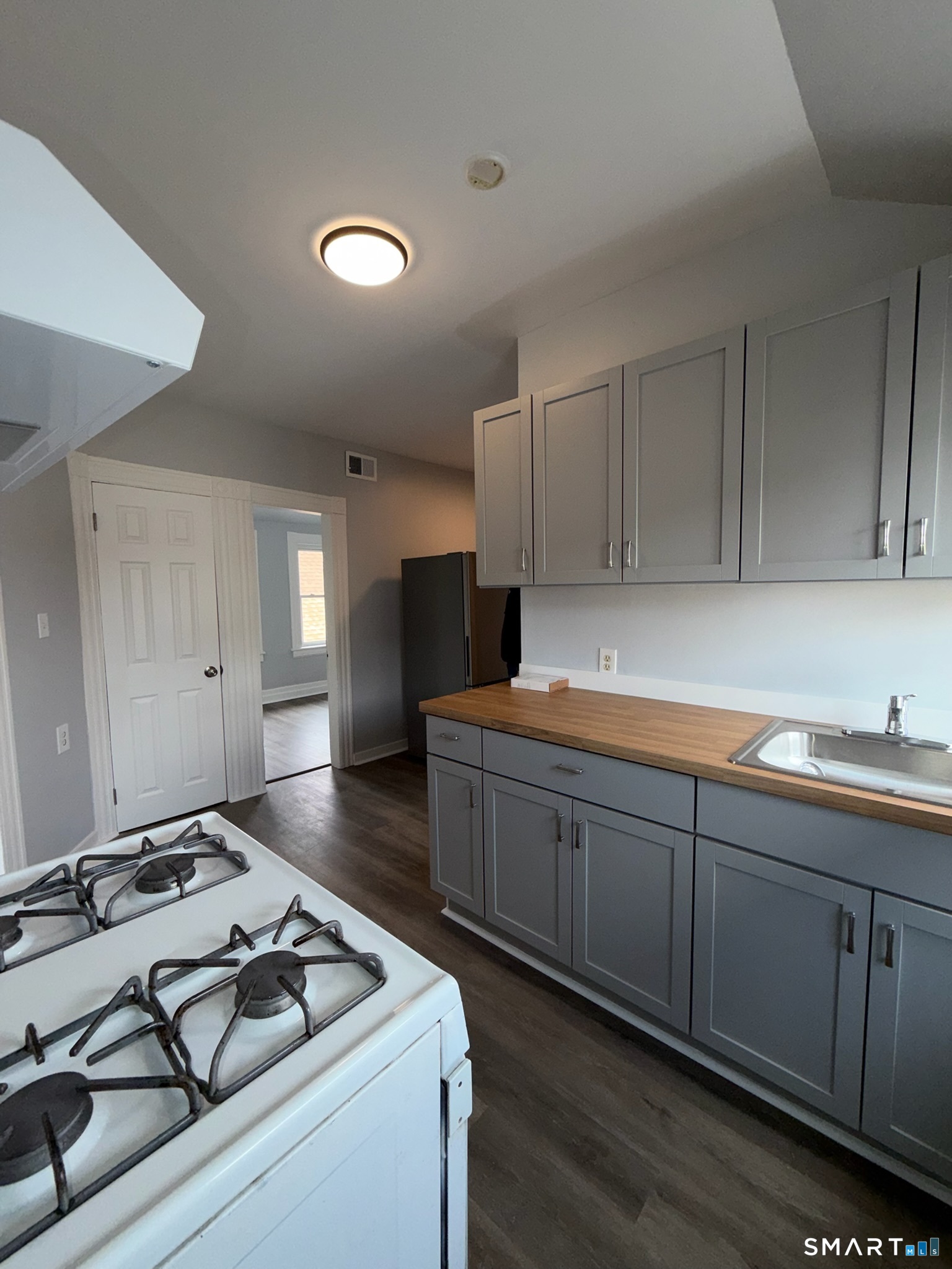 7-9 Wilson Street, Unit 3 Bridgeport, CT 06605 - Photo 6 of 14 a kitchen with sink stove and cabinets