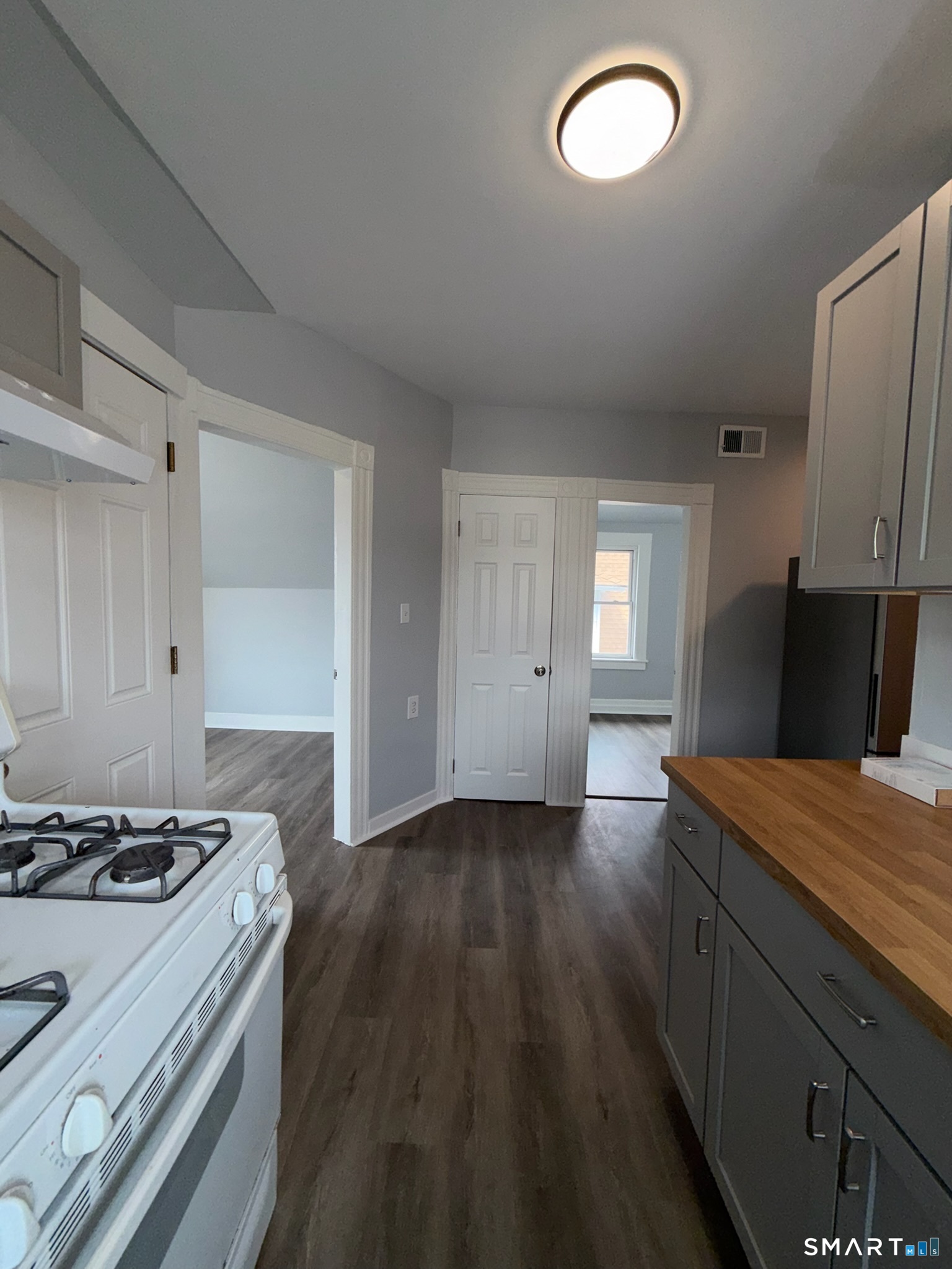 7-9 Wilson Street, Unit 3 Bridgeport, CT 06605 - Photo 7 of 14 a kitchen with granite countertop a stove and a sink