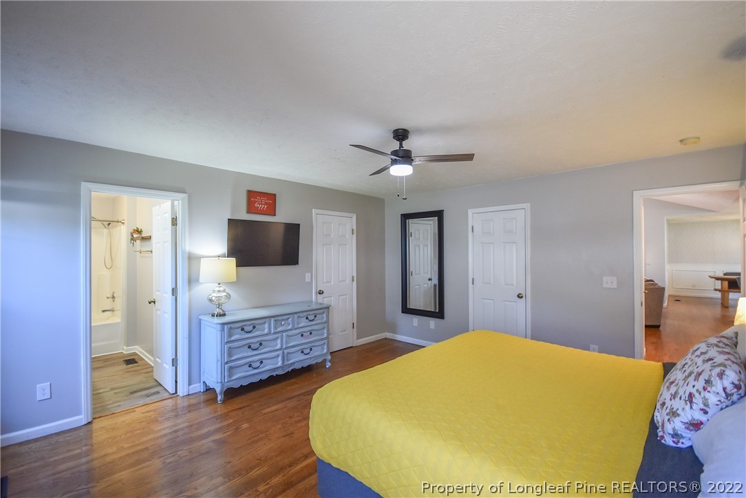 102 Chesapeake Road Cameron, NC 28326 - Photo 16 of 50 a bedroom with a bed and wooden floor
