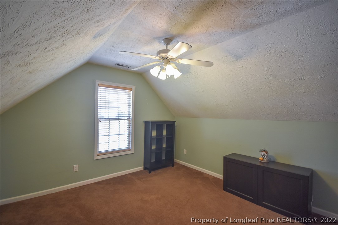 102 Chesapeake Road Cameron, NC 28326 - Photo 35 of 50 an empty room with windows and ceiling fan